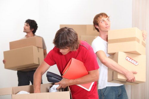 Removal van and movers preparing for a move in Manor House