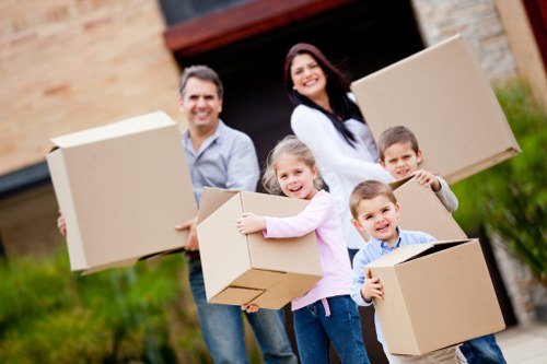 Professional movers carrying boxes from a flat in Manor House
