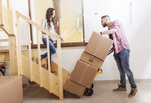 Local removals crew navigating narrow access near Manor House flats