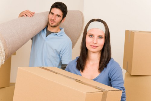 Professional movers handling boxes and household items near Manor House